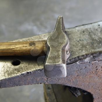 Royalty Free Photo of a Hammer Laying on an Anvil