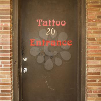 Royalty Free Photo of a Doorway Entrance to a Tattoo Parlor