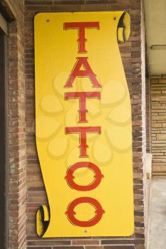 Royalty Free Photo of a Tattoo Sign Outside of a Tattoo Parlor