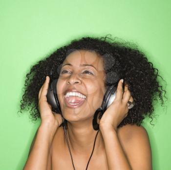 Royalty Free Photo of a Woman Listening to Music Through Headphones