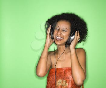 Royalty Free Photo of a Woman Listening to Music Through Headphones