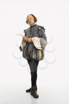 William Shakespeare in period clothing holding feather pen looking at viewer.