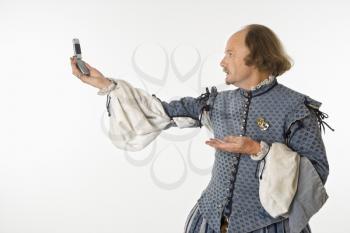 Royalty Free Photo of William Shakespeare in Period Clothing  Holding a Cellphone