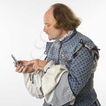 Royalty Free Photo of William Shakespeare in Period Clothing  Dialing a Cellphone
