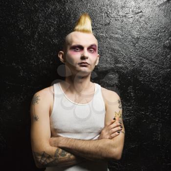Portrait of mid-adult Caucasian male punk with his arms crossed.