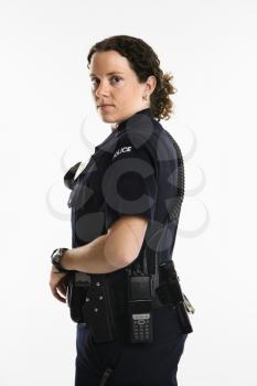 Royalty Free Photo of a Policewoman Standing With Hand on Gun Holster