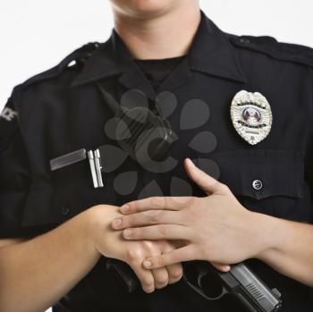 Royalty Free Photo of a Policewoman With Her Hand on Her Gun