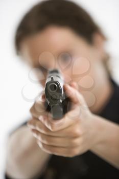 Royalty Free Photo of a Female Law Enforcement Officer Aiming a Gun
