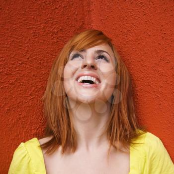 Portrait of smiling and laughing redhead looking up.