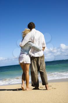 Royalty Free Photo of an Attractive Couple in a Sensual Embrace on Maui, Hawaii Beach