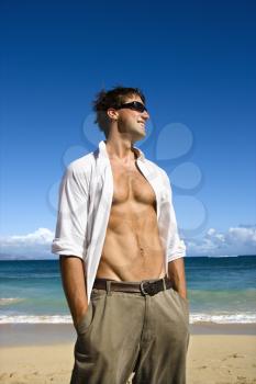 Royalty Free Photo of an Attractive Man Standing With His Shirt Unbuttoned on Maui, Hawaii Beach