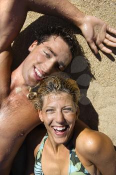 Royalty Free Photo of a Smiling Couple Lying in the Sand on Maui, Hawaii Beach