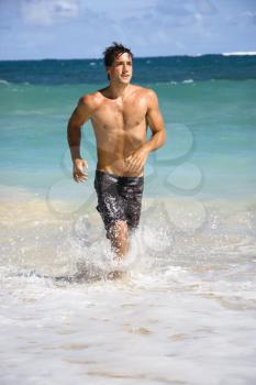 Royalty Free Photo of a Man Running on a Maui, Hawaii Beach