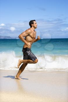 Royalty Free Photo of a Physically Fit Man Running on a Maui, Hawaii Beach