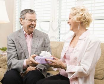 Royalty Free Photo of an Older Couple Exchanging Presents
