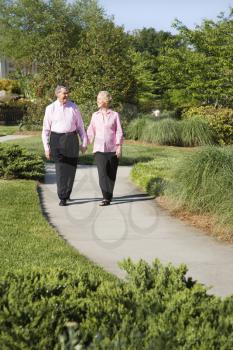 Royalty Free Photo of an Older Couple Walking Down a Sidewalk