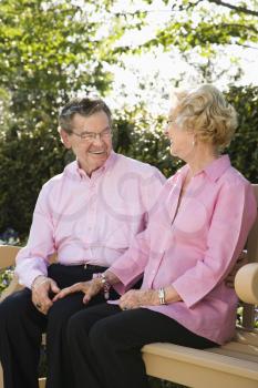 Royalty Free Photo of an Older Couple Sitting Together on  a Bench