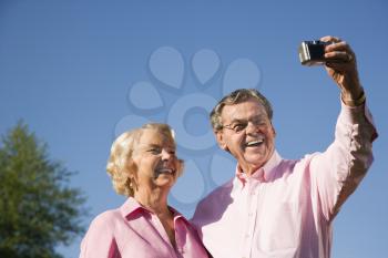 Royalty Free Photo of an Older Couple Taking a Picture of Themselves