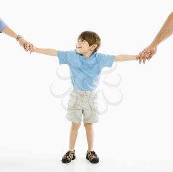 Royalty Free Photo of a Boy Holding His Parents Hands