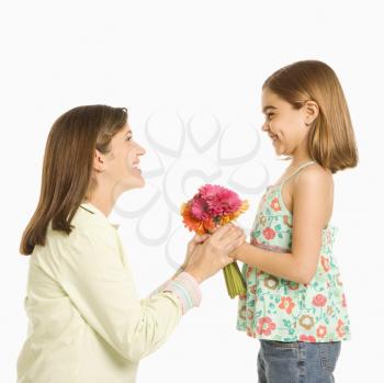 Royalty Free Photo of a Girl Giving a Bouquet of Flowers to Her Mother