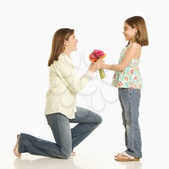 Royalty Free Photo of a Girl Giving a Bouquet of Flowers to Her Mother