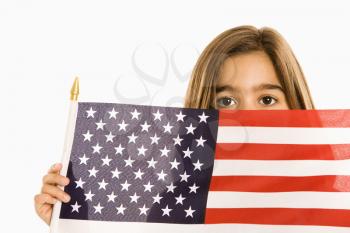 Royalty Free Photo of a Girl Peeking Over an American Flag