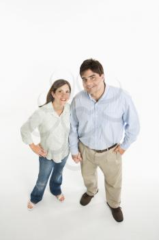 Overview of couple standing smiling against white background.