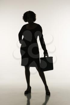 Royalty Free Photo of a Silhouette of a Businesswoman Holding a Briefcase