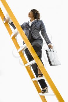 Royalty Free Photo of a Businesswoman Holding a Briefcase Climbing a Ladder