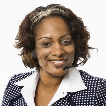 Royalty Free Photo of a Smiling Businesswoman Talking on a Telephone Headset