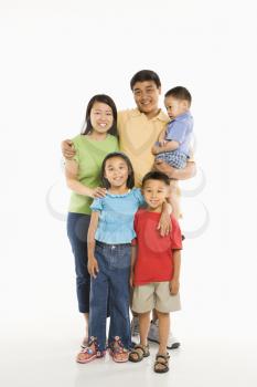 Royalty Free Photo of Parents With Three Children Standing in Front of a White Background