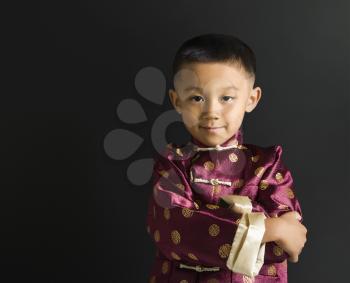 Royalty Free Photo of an Asian Boy Wearing Traditional Attire