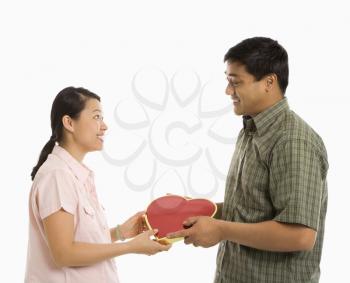 Royalty Free Photo of a Man Giving a Woman a Heart Shaped Box