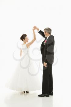 Royalty Free Photo of a Groom and Bride Dancing