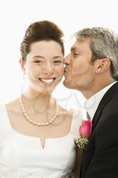 Royalty Free Photo of a Groom Kissing His Bride