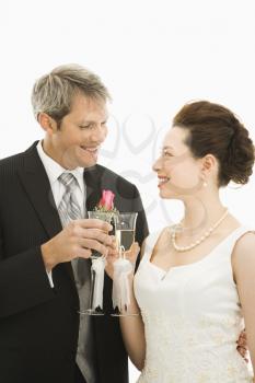 Royalty Free Photo of a Groom and Bride Toasting With Champagne Glasses