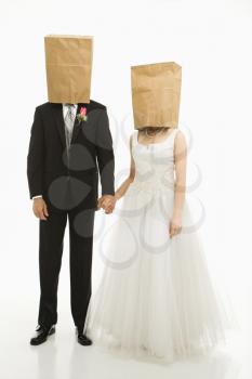 Royalty Free Photo of a Bride and Groom With Paper Bags Over Their Heads