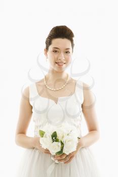 Royalty Free Photo of a Bride Holding a Bouquet of Roses