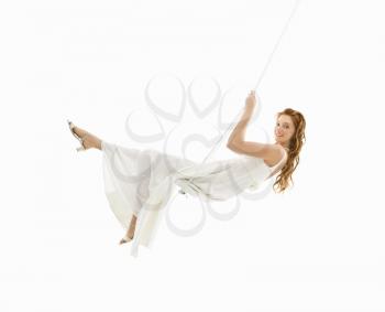 Royalty Free Photo of a Bride Swinging on a Swing Set