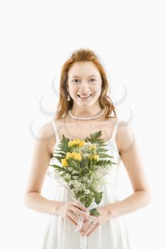 Royalty Free Photo of a Bride Holding a Bouquet and Smiling