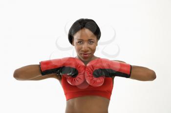 Royalty Free Photo of a Woman Wearing Boxing Gloves Throwing Playful Punches