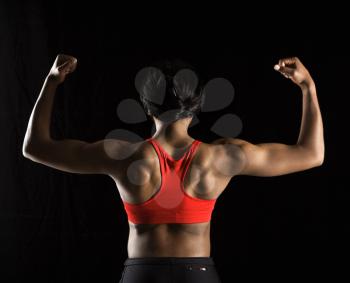 Royalty Free Photo of a Back View of a Muscular African American Woman With Biceps Flexed
