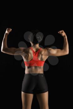 Royalty Free Photo of a Back View of a Muscular African American Woman With Biceps Flexed