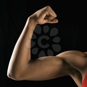Royalty Free Photo of a Woman Flexing Her Muscular Bicep