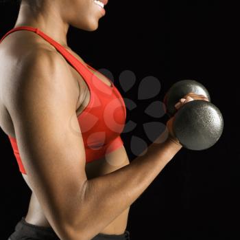 Royalty Free Photo of the Torso of an African American Woman Lifting a Dumbbell