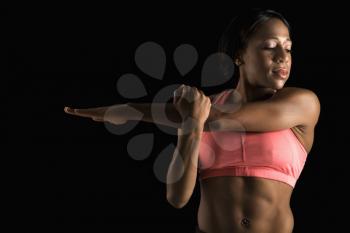 Royalty Free Photo of a Woman in a Sports Bra Stretching