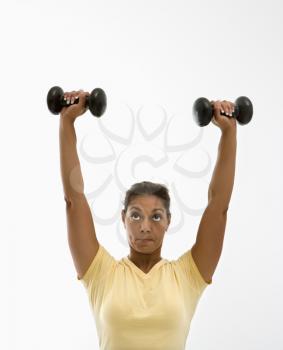 Royalty Free Photo of a Woman Holding Dumbbells Over Her Head