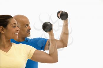 Royalty Free Photo of a Man and Woman Exercising With Dumbbells Doing Bicep Curls
