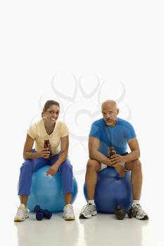 Royalty Free Photo of a Man and Woman Sitting on Exercise Balls