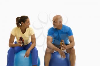 Royalty Free Photo of a Man and Woman Balancing on Exercise Balls